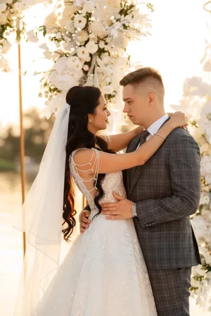 Happy bride and groom celebrating outdoors with flowers