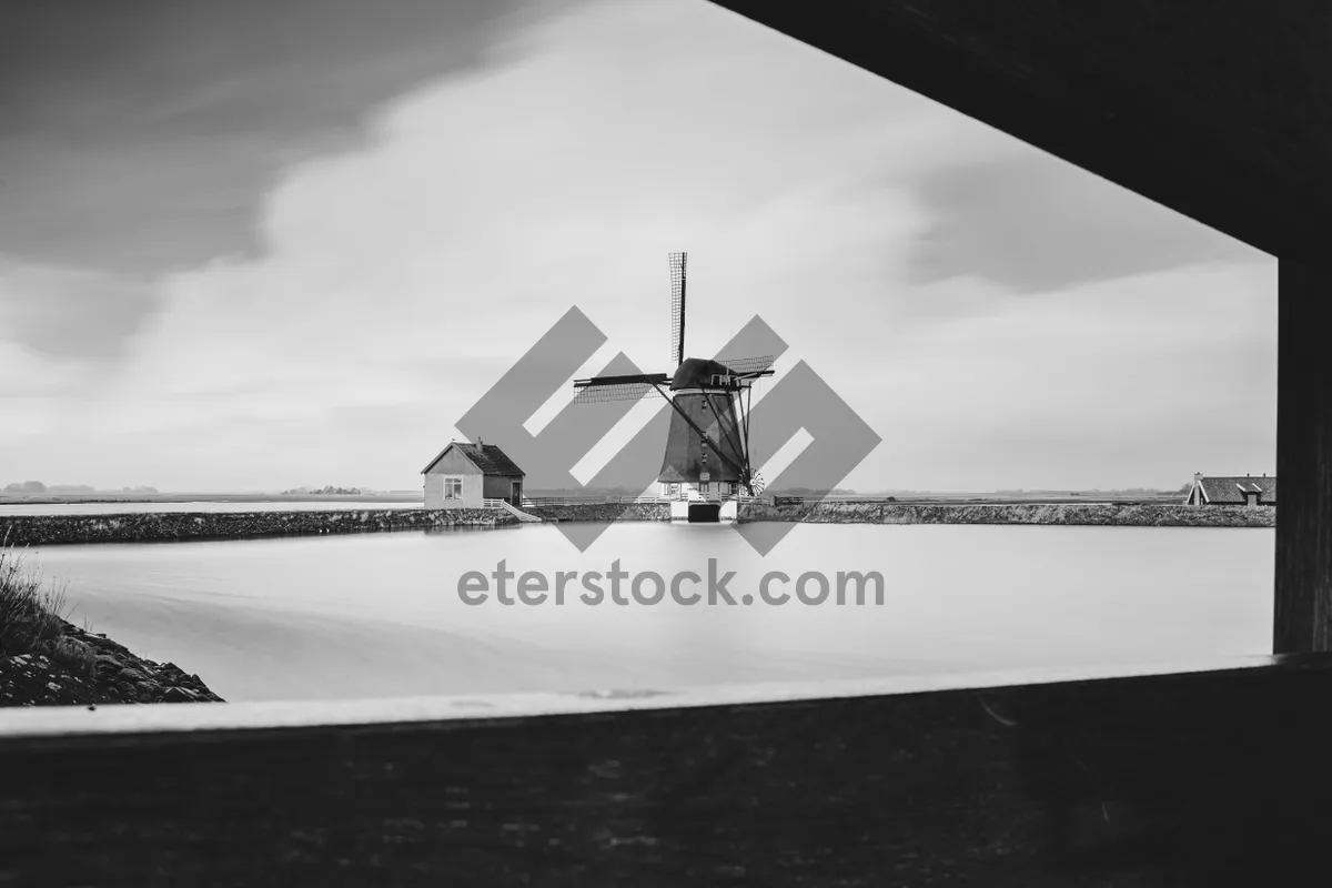 Picture of Cityscape with River and Wind Turbine