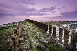 Scenic Coastal Barrier with Turquoise Ocean and Rocky Shore