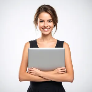 Attractive brunette businesswoman smiling while holding laptop.