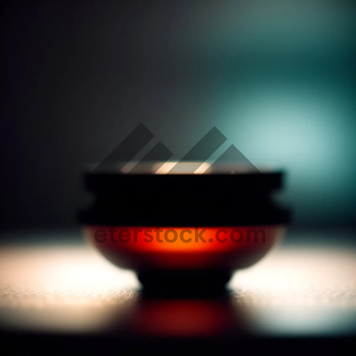 Picture of Wineglass filled with rich red beverage in dimly lit restaurant.