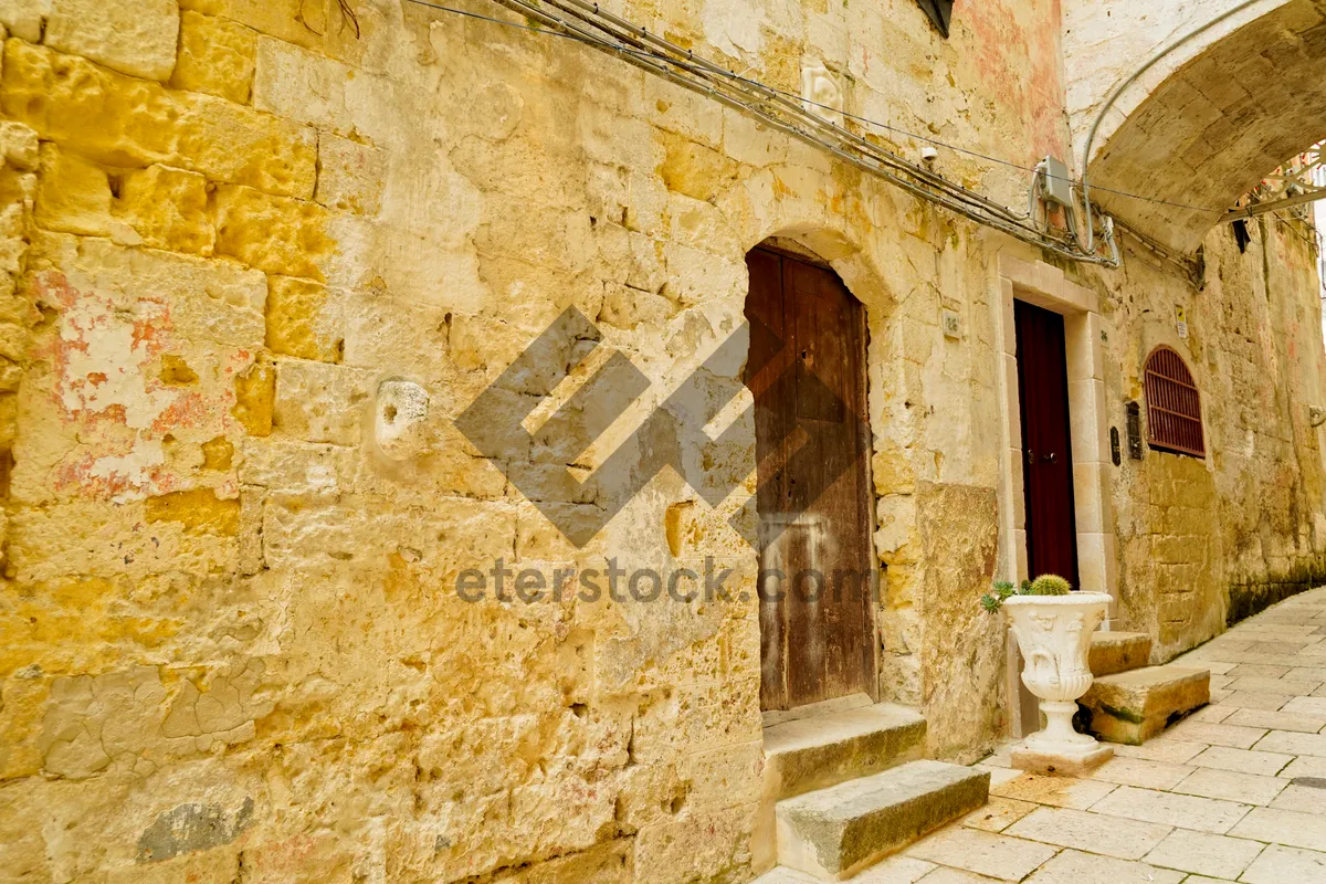 Picture of Medieval church with stone walls and arched doorway.