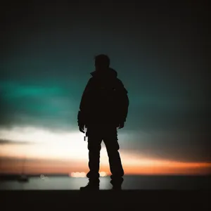 Serene Sunset Silhouette over Beach Waves