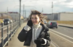 Attractive brunette lady in stylish coat smiling