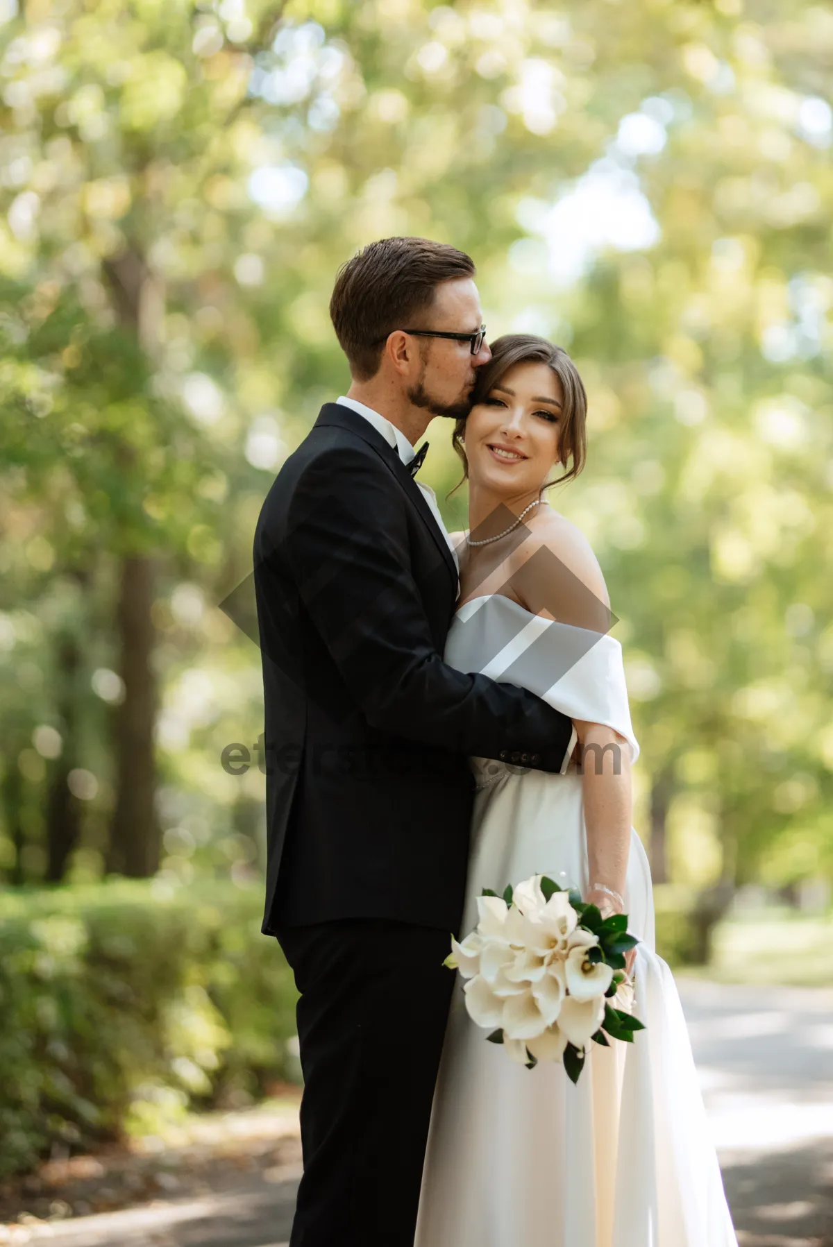 Picture of Happy newlywed couple smiling outdoors on their wedding day