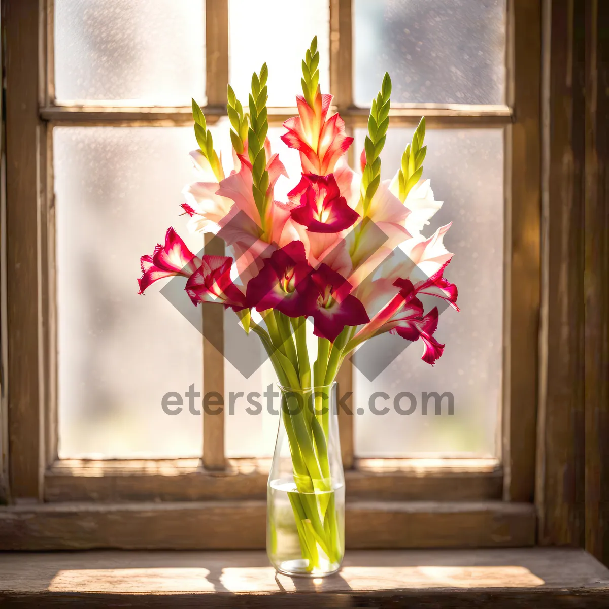 Picture of Pretty pink floral arrangement in glass vase on windowsill