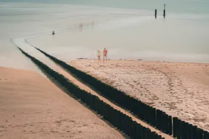 Tropical island beach with volleyball net under clear sky