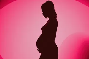 Silhouette of a Black Woman and Man’s Belly