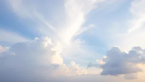 Clear summer sky with fluffy clouds and bright sun