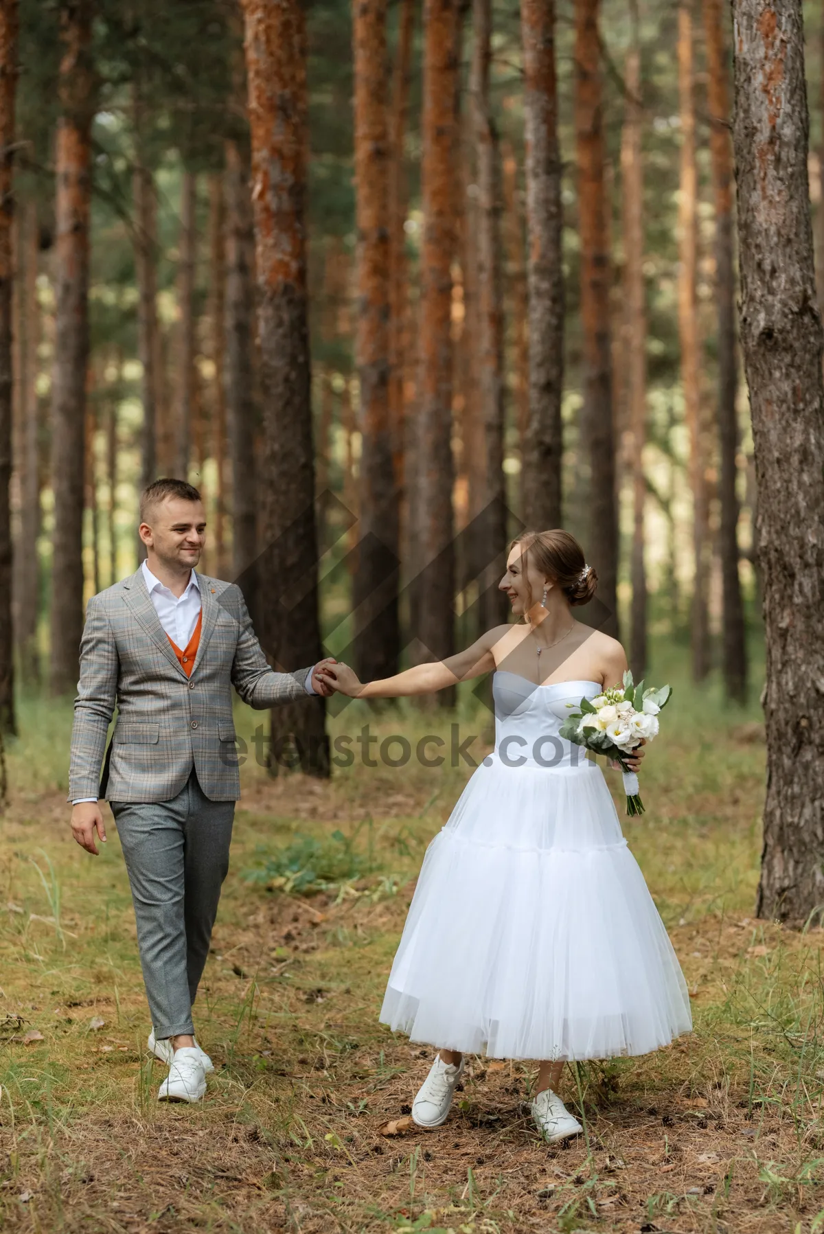 Picture of Happy Bride and Groom Embrace on Wedding Day