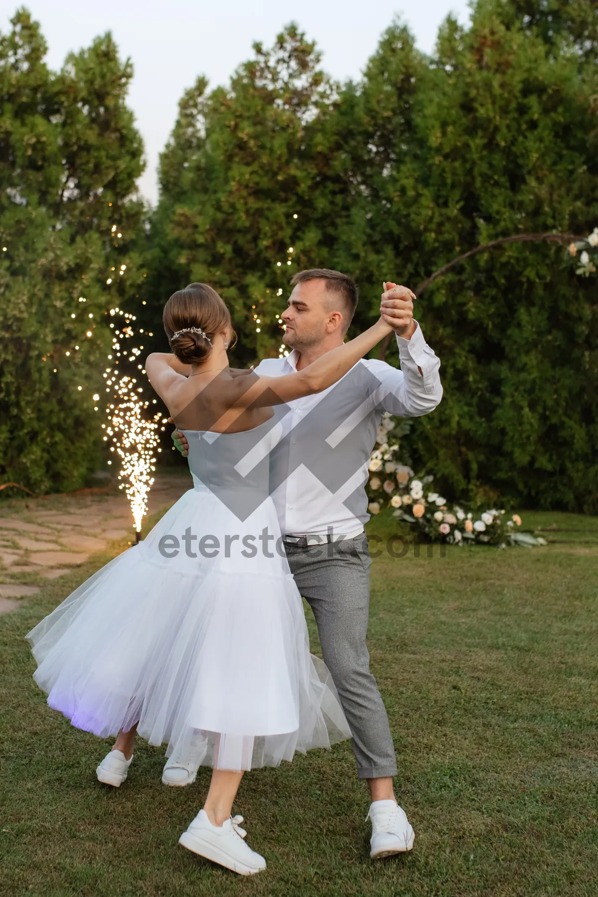 Picture of Happy groom and bride celebrating wedding day outdoors.