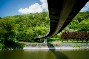 Summer landscape with bridge over tranquil river