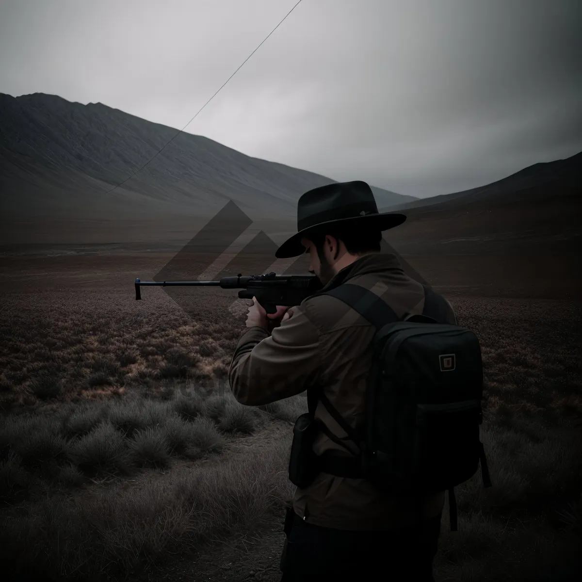 Picture of Mountain Man with Assault Rifle and Tripod"
or
"Male Shooter with Automatic Rifle on Tripod