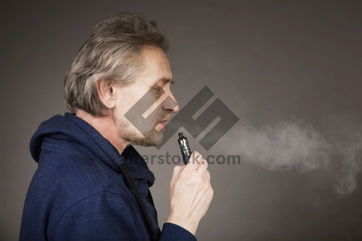 Picture of Professional musician in suit holding microphone and phone.