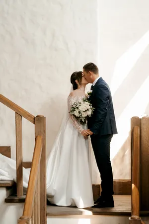 Happy newlyweds with bouquet on wedding day.