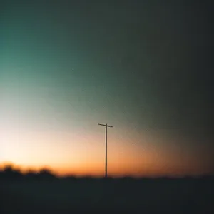 Sunset Wind Turbine Over Vibrant Landscape