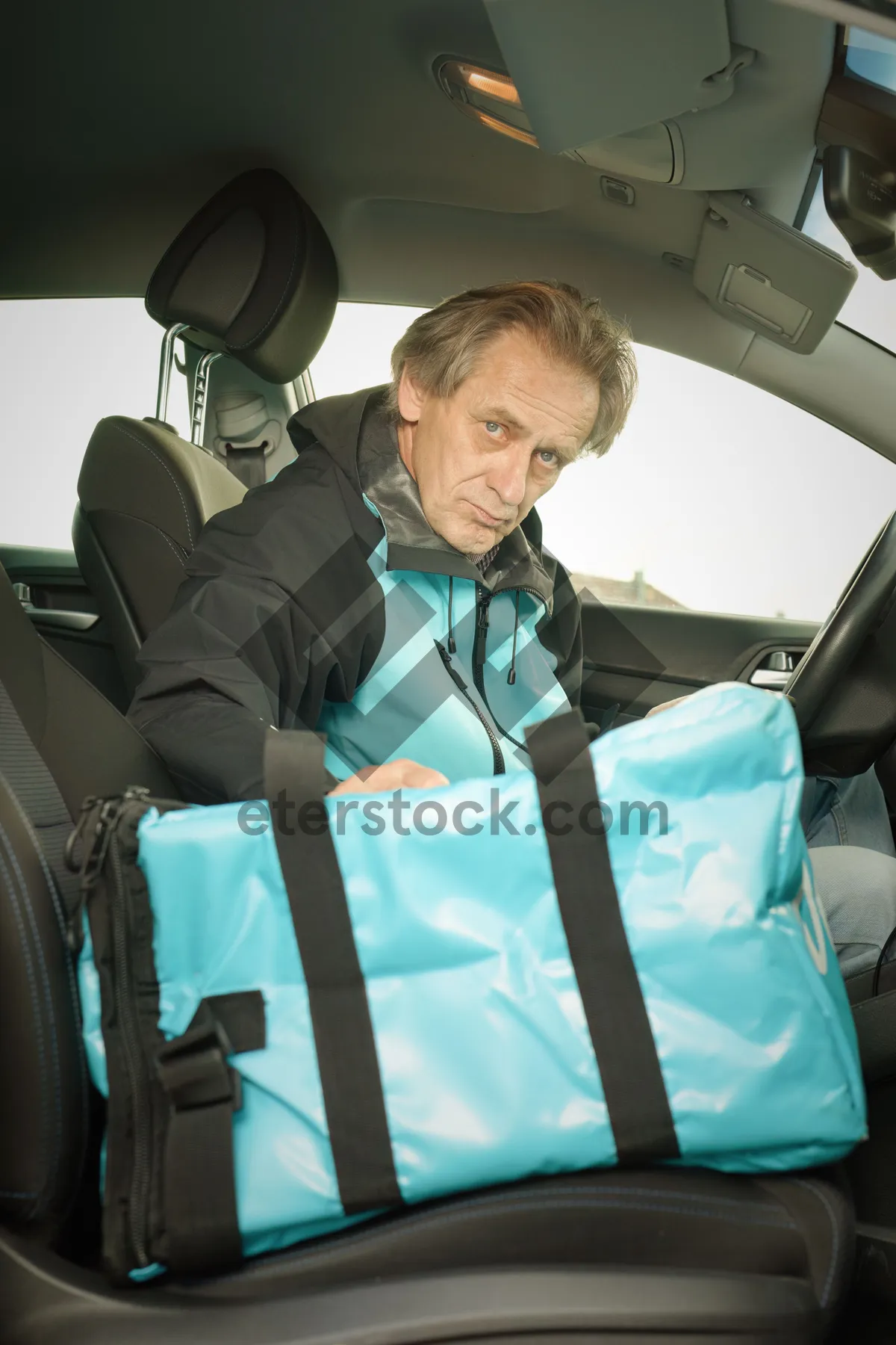 Picture of Happy man driving car with seat belt on.