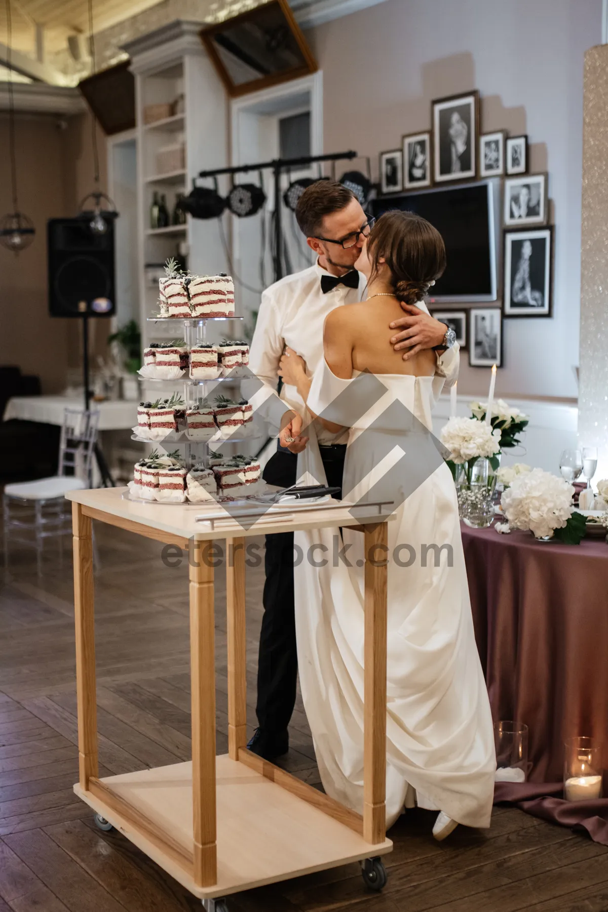 Picture of Happy waiter serving a couple in a kitchen.