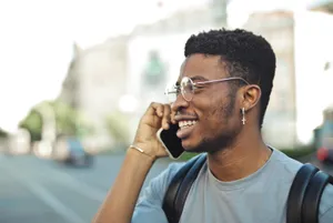 Smiling professional businessman using cellphone for business communication