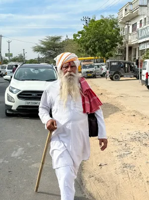 Man with crutch walking with staff