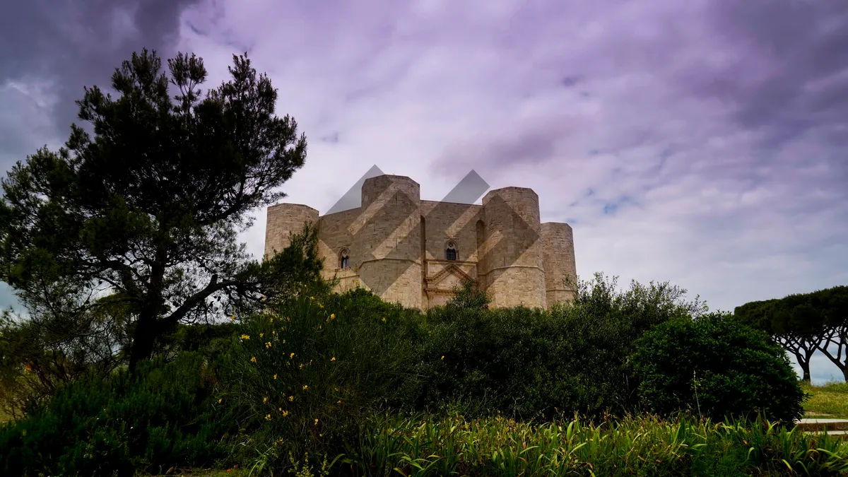 Picture of Medieval castle tower against scenic historic landscape.