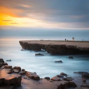 Idyllic Coastal Seascape: Serene Beachside Escape with Crystal Clear Waters"
(Note: This is a suggested text for the describing name of an image based on the provided tags)