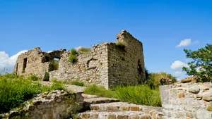 Medieval castle fortress overlooking ancient ruins and fortification.