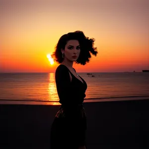 Silhouette of attractive model enjoying beach at sunset