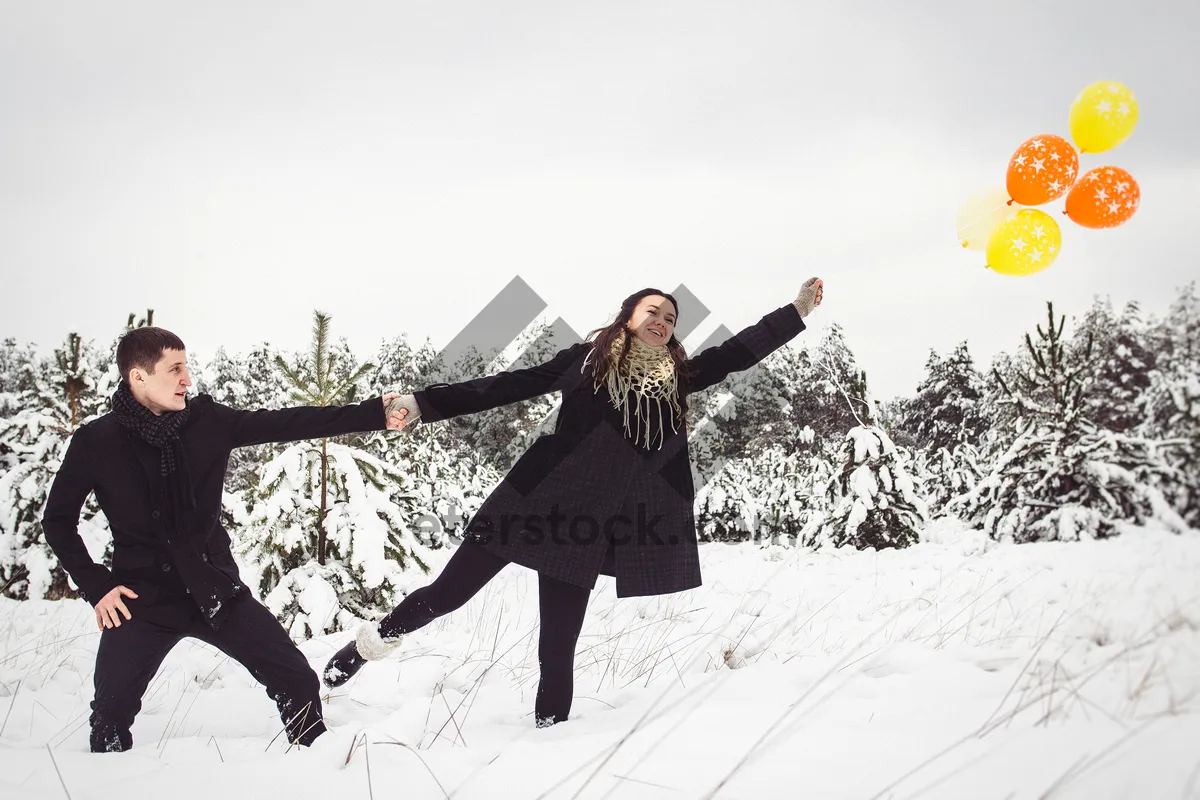 Picture of Happy man jumping on snowy mountain during winter ski