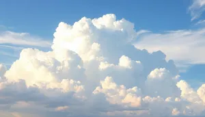 Bright sunny summer landscape with fluffy clouds in clear sky.