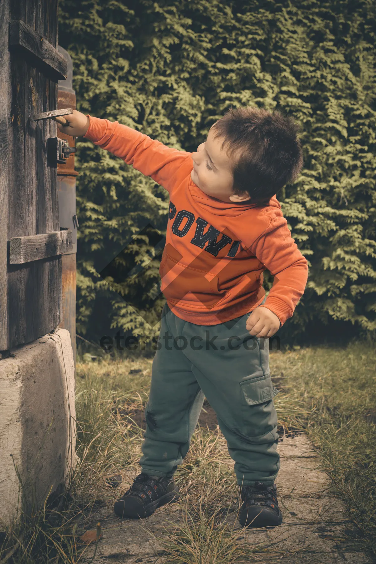 Picture of Happy boy playing with an air gun outdoors.