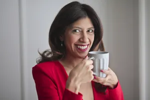 Happy Businesswoman Holding Cup of Coffee Smiling