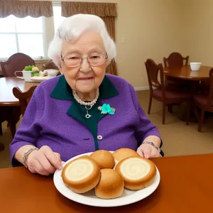 Happy Grandfather and Wife Enjoying Family Meal in the Kitchen