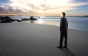 Silhouette of Man on Beach at Sunset.