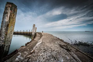 Tower on Beach with Rocks and Waves