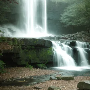 Serene Waterfall Flowing Through Rustic Forest Landscape