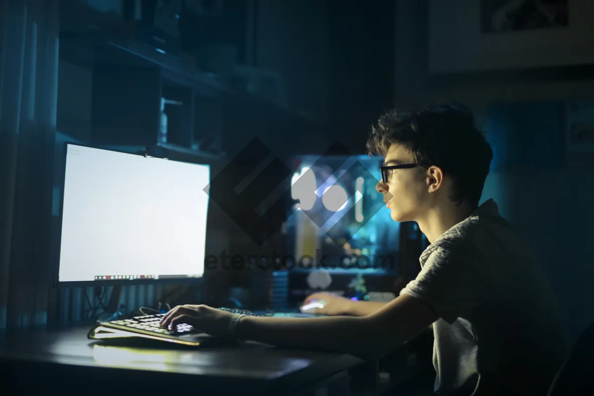 Picture of Happy DJ man working at laptop in office.