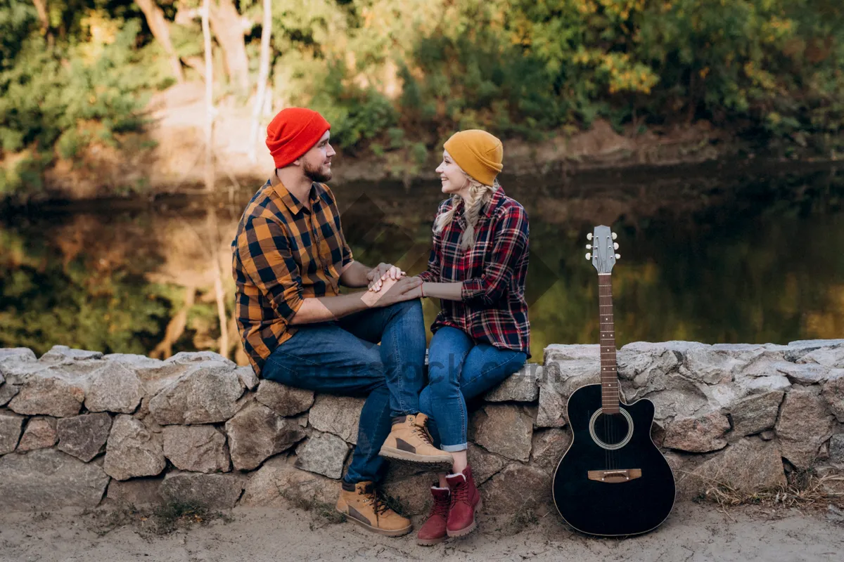 Picture of Man playing drums and guitar outdoors