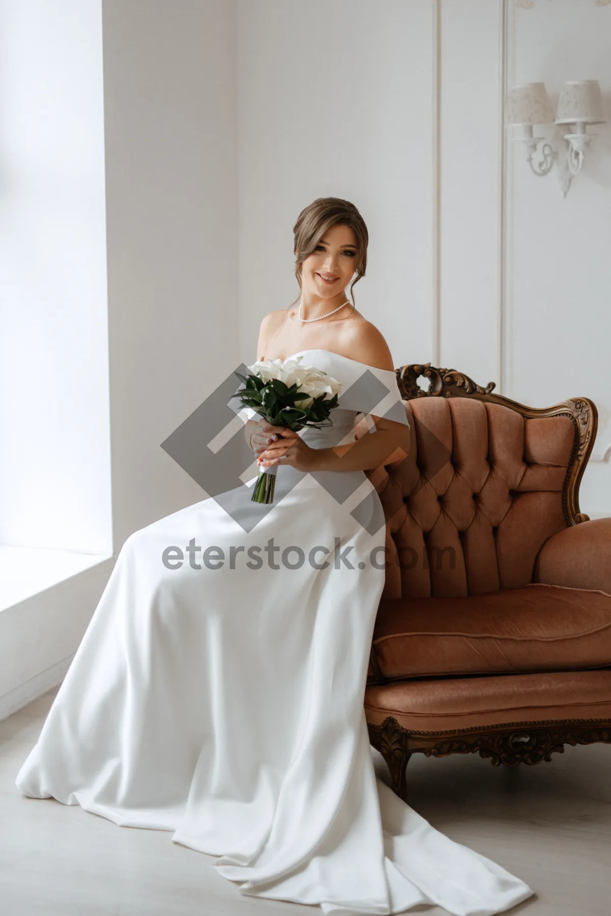 Picture of Happy newlywed couple holding bouquet of flowers at wedding.