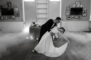 Happy couple celebrating wedding with bouquet of flowers