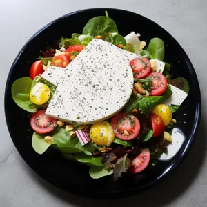 Healthy gourmet vegetable salad with grilled cheese and tomato.