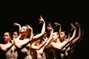 Attractive fashion dancers performing happy group dance