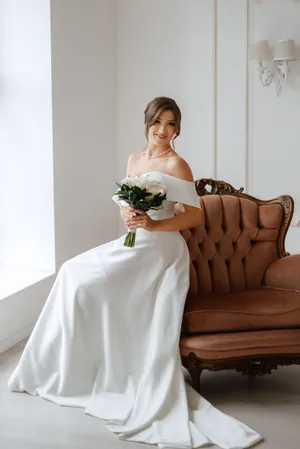 Happy newlywed couple holding bouquet of flowers at wedding.