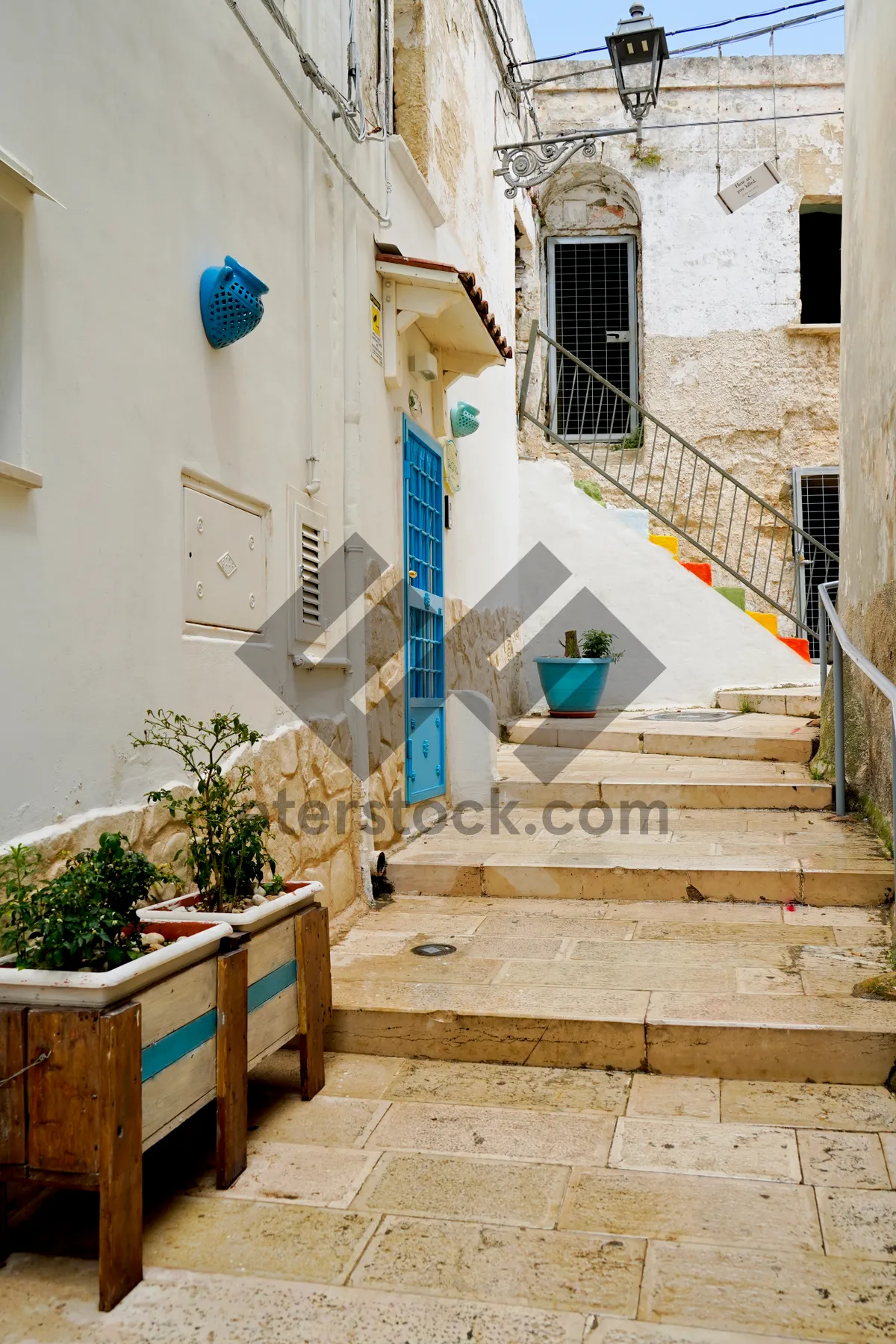 Picture of Old city street featuring ancient brick houses and stone walls.