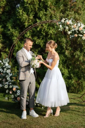 Happy wedding couple smiling outdoors on their special day.