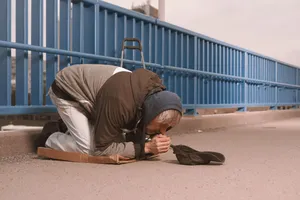 Adult man with sleeping bag outdoors