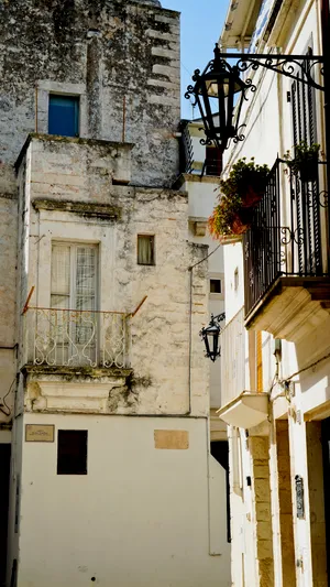 Old city stone building with windows and balcony