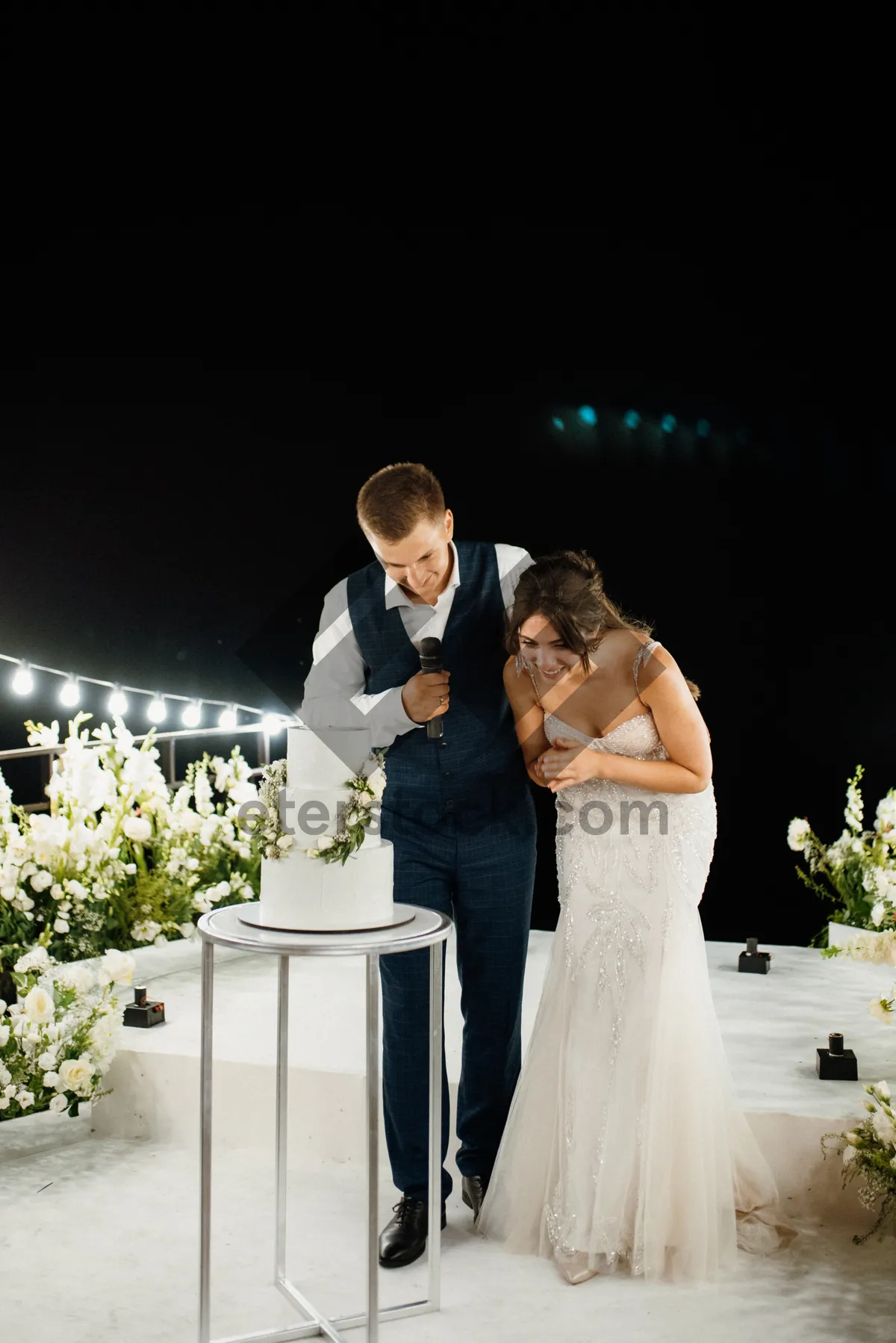 Picture of Happy couple celebrates wedding day outdoors with flowers