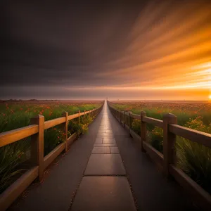 Scenic coastal suspension bridge overlooking sunset.