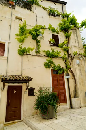 Old town house with balcony, stone facade.